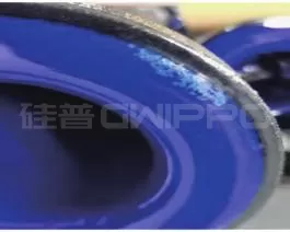 Off-color spots on the enamel surface caused by oil/water vapor contamination